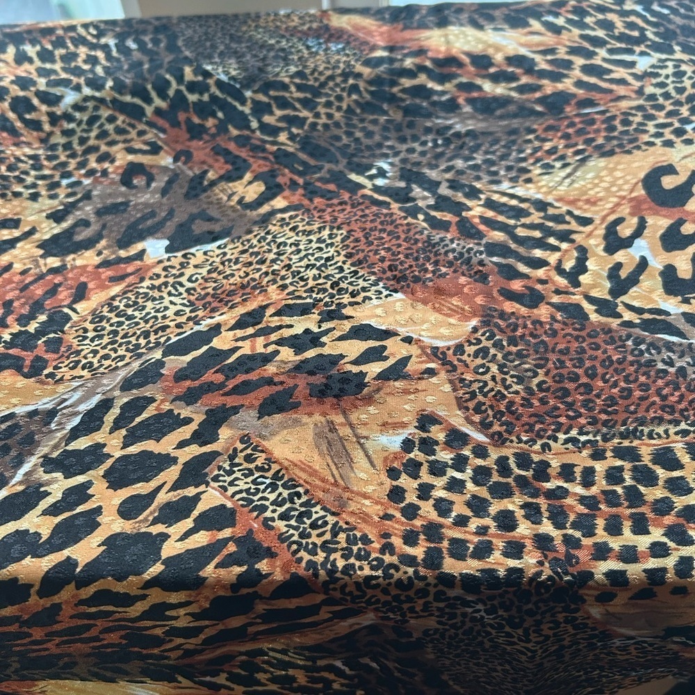 Textured leopard print fabric with brown, orange, and black hues. 45” by 41”